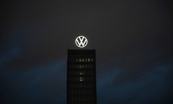 The Volkswagen logo shines on the brand tower on the grounds of the VW main plant. Pho